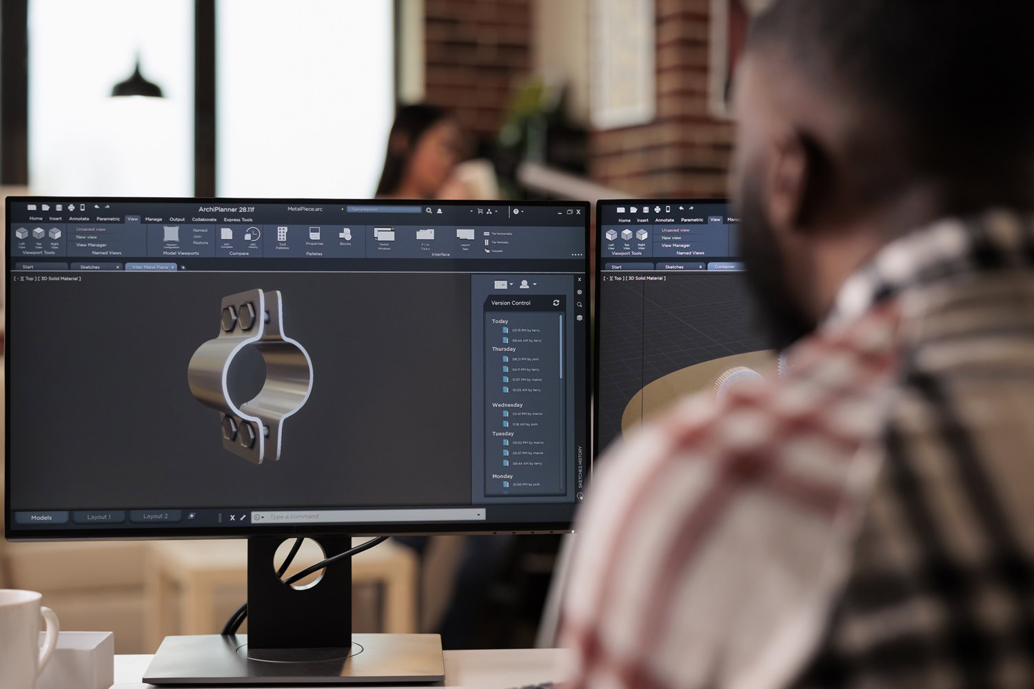 CAD engineer working on a 3D model of industrial machinery and gears